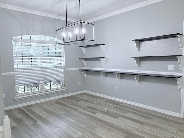 9317 Shylana Ave, Amarillo, TX 79119 - unfurnished dining area with a chandelier, ornamental molding, light wood-type flooring, and baseboards