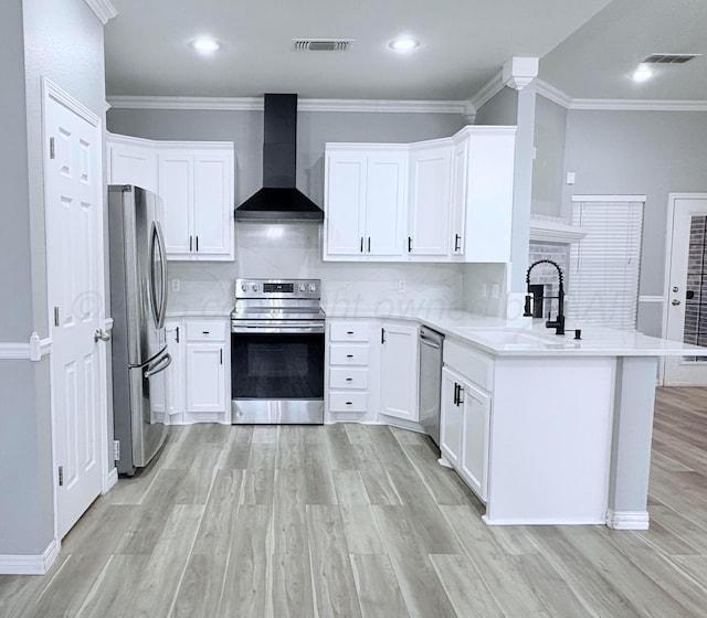 9317 Shylana Ave, Amarillo, TX 79119 - kitchen featuring stainless steel appliances, wall chimney range hood, a peninsula, a sink, and tasteful backsplash