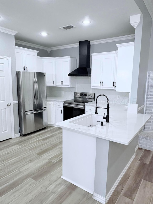 9317 Shylana Ave, Amarillo, TX 79119 - kitchen with stainless steel appliances, wall chimney exhaust hood, a sink, a peninsula, and light wood-style floors