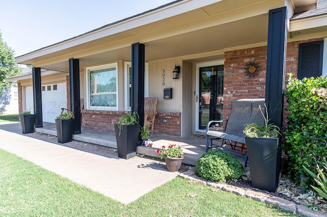 entrance to property featuring covered porch and a garage