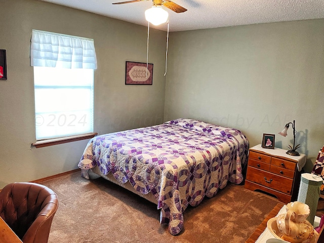 bedroom featuring carpet, a textured ceiling, and ceiling fan