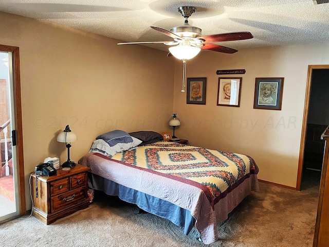 carpeted bedroom featuring ceiling fan and a textured ceiling