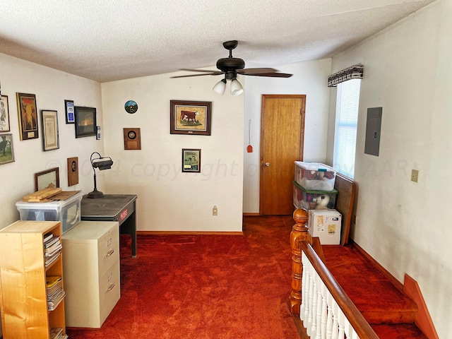 carpeted office with electric panel, a textured ceiling, and ceiling fan