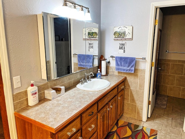 bathroom featuring tile walls and vanity