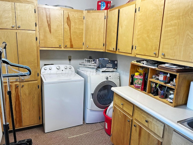 washroom featuring cabinets and independent washer and dryer