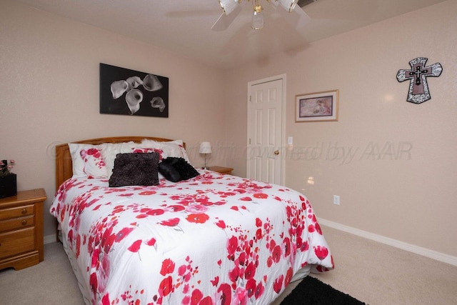 carpeted bedroom featuring baseboards and a ceiling fan