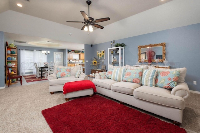 carpeted living room featuring recessed lighting, ceiling fan with notable chandelier, a raised ceiling, and baseboards