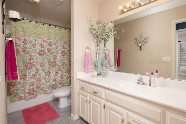 full bath with visible vents, toilet, shower / tub combo with curtain, and vanity