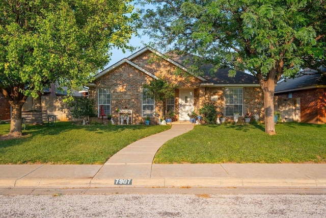 view of front of property with a front lawn and brick siding