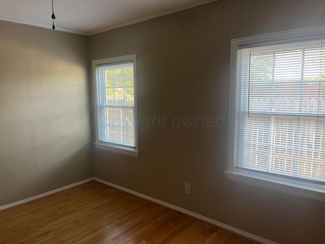 2409 S Tyler St, Amarillo, TX 79109 - unfurnished room with wood finished floors, baseboards, and crown molding