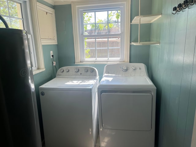 2409 S Tyler St, Amarillo, TX 79109 - laundry room with independent washer and dryer, plenty of natural light, and wood walls