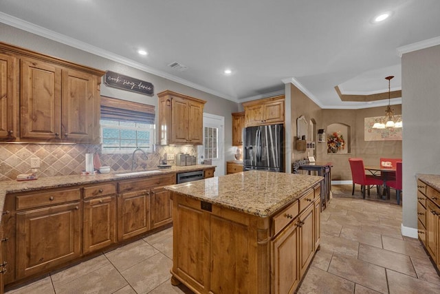 6905 Spring Cherry Ln, Amarillo, TX 79124 - kitchen with appliances with stainless steel finishes, a kitchen island, tasteful backsplash, brown cabinetry, and recessed lighting
