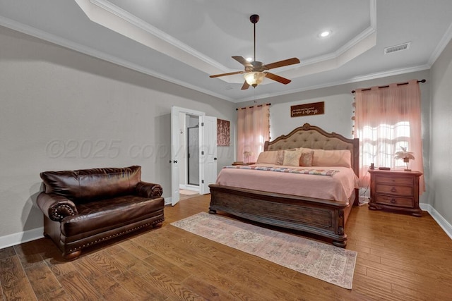 6905 Spring Cherry Ln, Amarillo, TX 79124 - bedroom with a tray ceiling, crown molding, wood finished floors, a ceiling fan, and recessed lighting