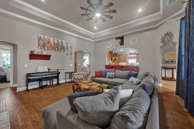 6905 Spring Cherry Ln, Amarillo, TX 79124 - living room featuring arched walkways, a raised ceiling, ceiling fan, wood finished floors, and ornamental molding
