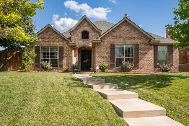 6905 Spring Cherry Ln, Amarillo, TX 79124 - view of front of property with brick siding, a chimney, and roof with shingles