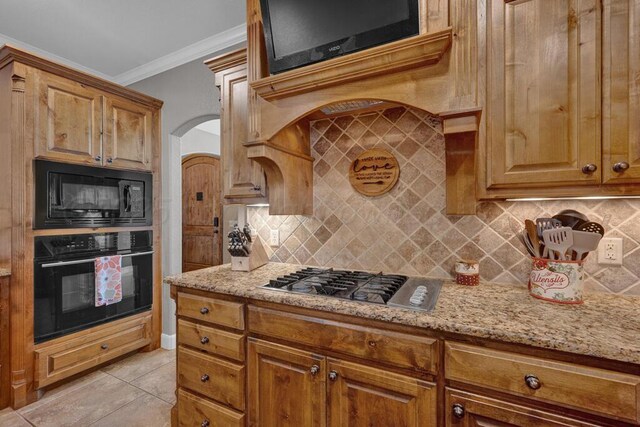 6905 Spring Cherry Ln, Amarillo, TX 79124 - kitchen with black appliances, crown molding, light stone counters, and tasteful backsplash