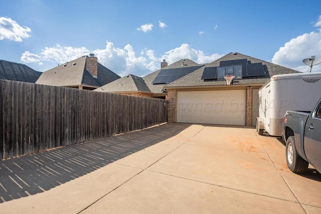 6905 Spring Cherry Ln, Amarillo, TX 79124 - garage with driveway and solar panels