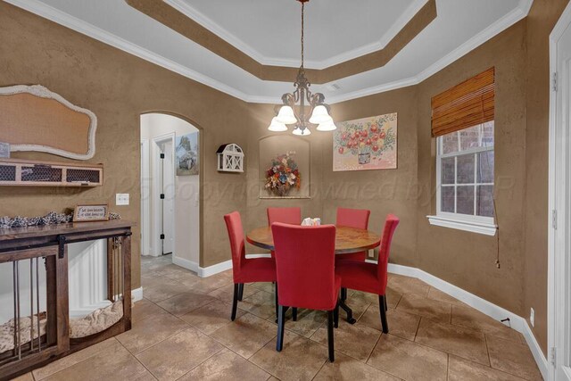 6905 Spring Cherry Ln, Amarillo, TX 79124 - dining area featuring a chandelier, arched walkways, ornamental molding, a tray ceiling, and tile patterned floors