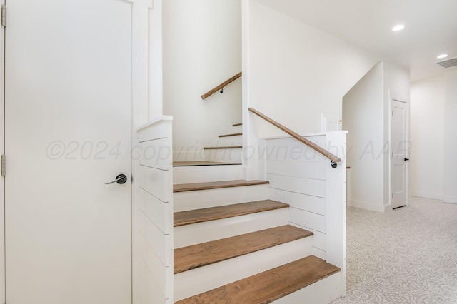 staircase featuring recessed lighting, carpet flooring, visible vents, and baseboards