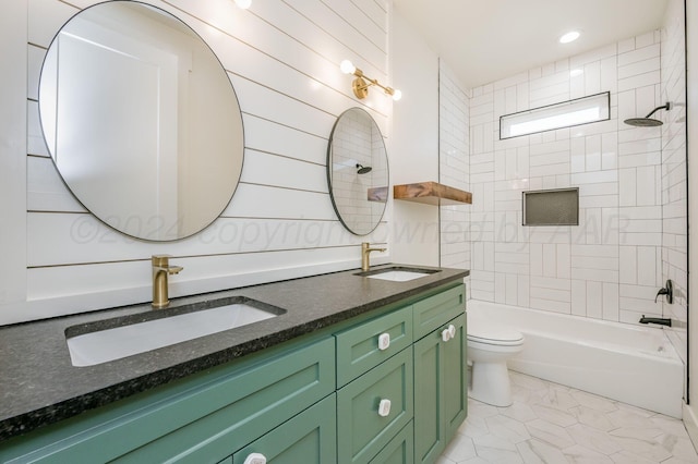 full bath featuring toilet, double vanity, shower / washtub combination, and a sink