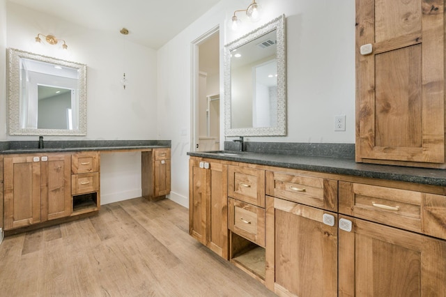 full bathroom featuring visible vents, vanity, baseboards, and wood finished floors