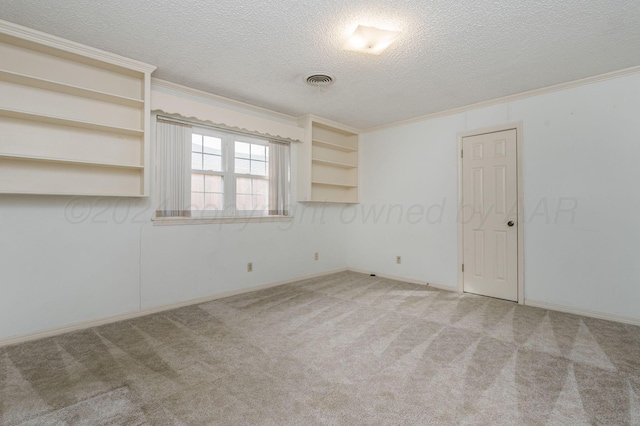 carpeted empty room with a textured ceiling and ornamental molding
