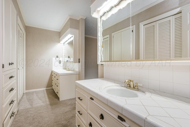 bathroom with vanity, crown molding, and backsplash