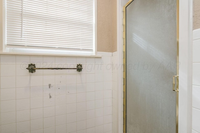bathroom with a shower with shower door