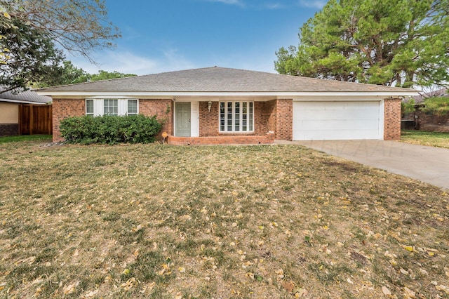 ranch-style home featuring a front lawn and a garage