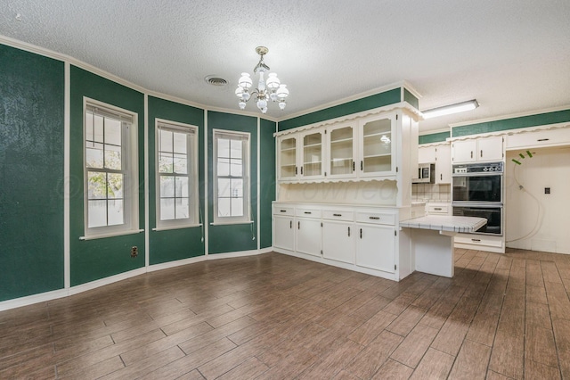 kitchen with tile countertops, hanging light fixtures, dark hardwood / wood-style floors, and white cabinets