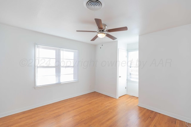 spare room with ceiling fan and light wood-type flooring