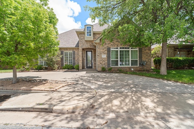 7323 Parkway Dr, Amarillo, TX 79119 - view of front facade featuring brick siding and roof with shingles