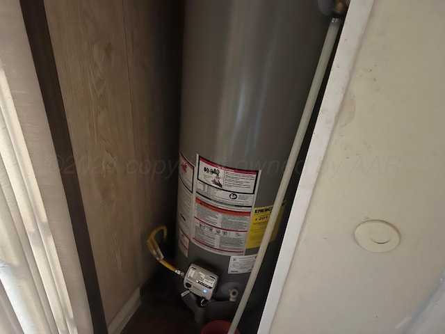 utility room featuring water heater