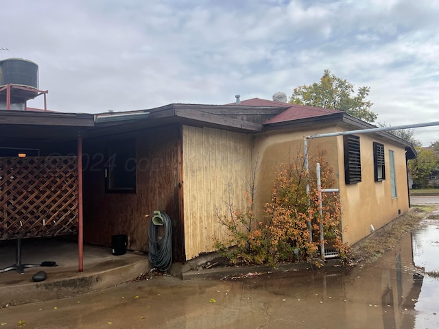 view of property exterior with a patio area