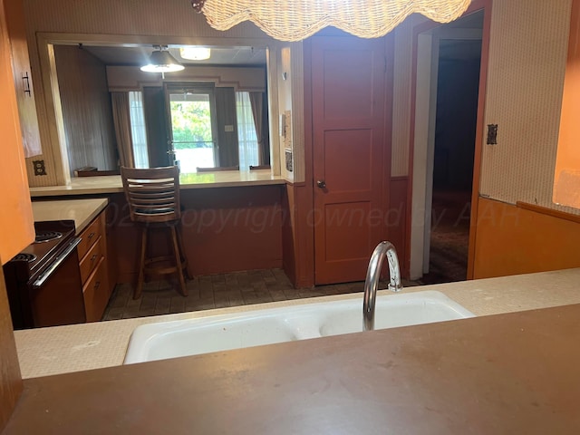 kitchen with black / electric stove and sink