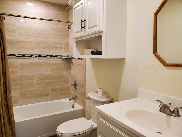 full bathroom featuring vanity, tiled shower / bath, and toilet