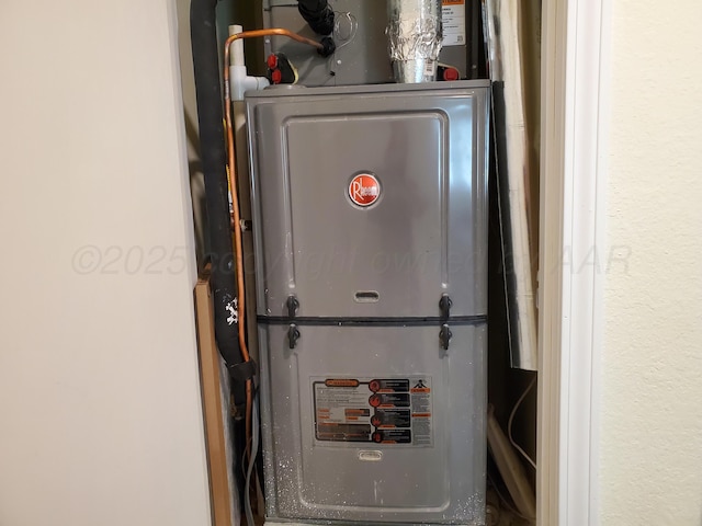 utility room featuring heating unit