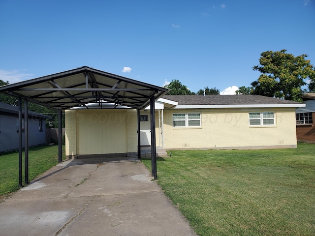 view of parking with a carport and a yard