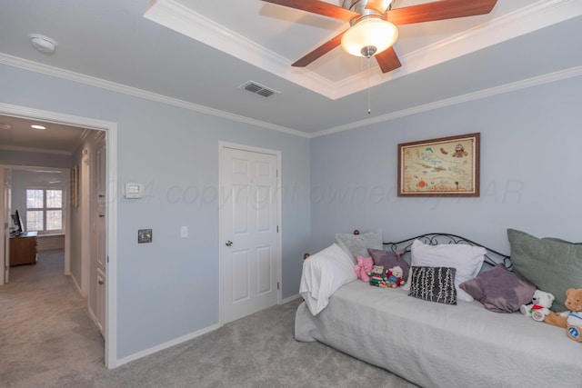 carpeted bedroom with a raised ceiling, ceiling fan, and crown molding