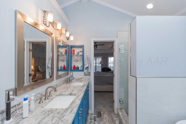 bathroom featuring vanity, vaulted ceiling, hardwood / wood-style flooring, ceiling fan, and ornamental molding