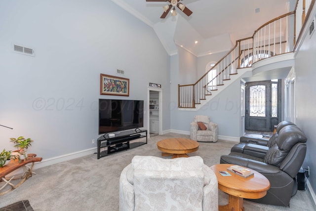 carpeted living room with crown molding, high vaulted ceiling, and ceiling fan