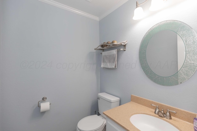 bathroom with crown molding, vanity, and toilet