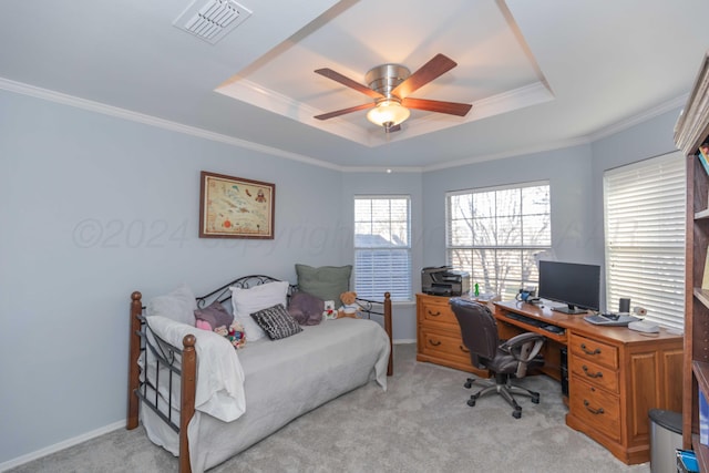 carpeted bedroom with ceiling fan, a raised ceiling, and ornamental molding