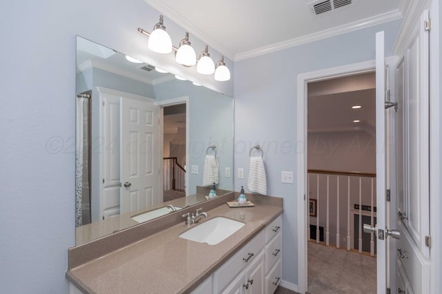 bathroom featuring crown molding and vanity