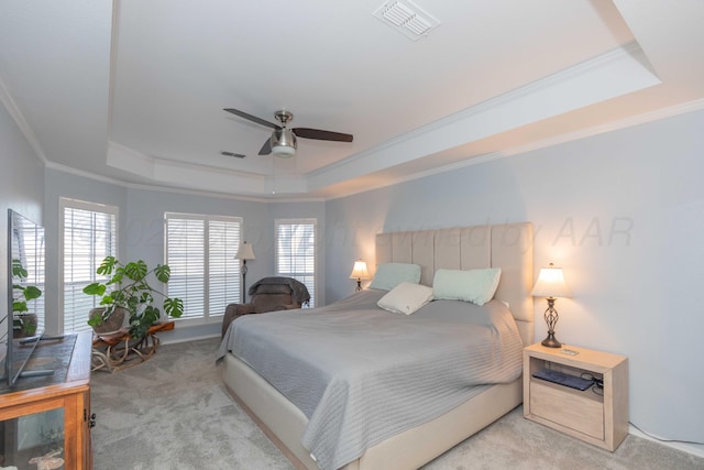 bedroom featuring a tray ceiling, ceiling fan, and light colored carpet