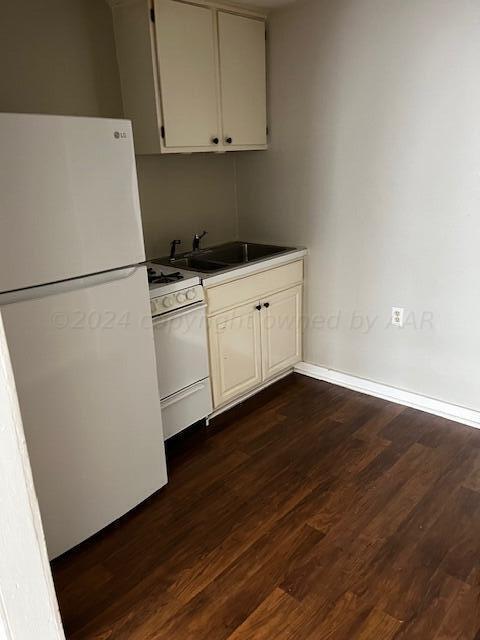 2122 S Hayden St, Amarillo, TX 79109 - kitchen with white appliances and dark wood-style flooring