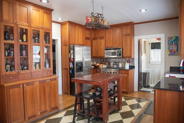 2122 S Hayden St, Amarillo, TX 79109 - kitchen with appliances with stainless steel finishes, brown cabinetry, dark countertops, recessed lighting, and tasteful backsplash