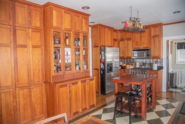 2122 S Hayden St, Amarillo, TX 79109 - kitchen featuring stainless steel appliances, brown cabinetry, decorative backsplash, recessed lighting, and dark countertops
