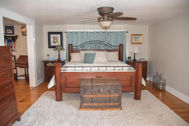 2122 S Hayden St, Amarillo, TX 79109 - bedroom featuring wood finished floors, a spacious closet, and a ceiling fan
