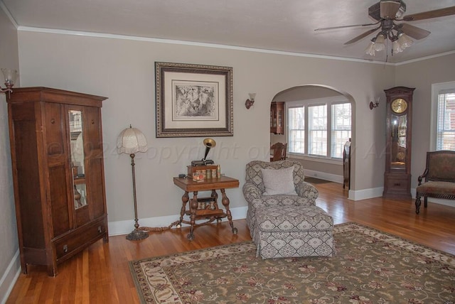2122 S Hayden St, Amarillo, TX 79109 - sitting room featuring wood finished floors, plenty of natural light, arched walkways, a ceiling fan, and crown molding